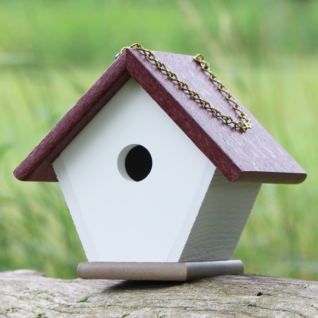 Cherry wren house sitting on log